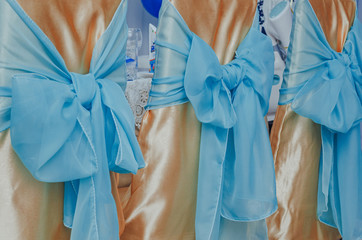 blue holiday bows on chairs