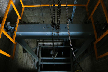 Technician welding to maintain Lift in factory