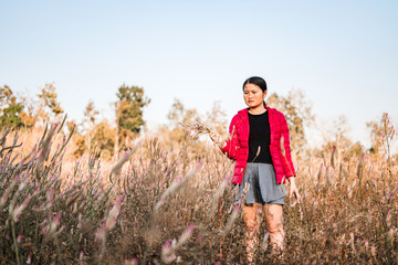 The girl is traveling in the grass field cockscomb grass.