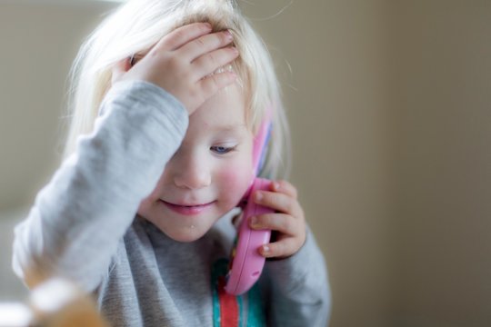 Toddler playing with toy phone