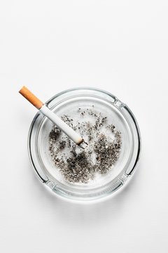 Cigarette on ash tray with ash