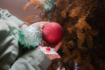 Girl's hands holding christmas ornaments