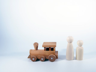 wooden train toy and wooden figurines of man and woman.concept travel.