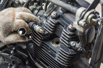 hand of Mechanic Check and a spark plugs . (maintenance) selective focus