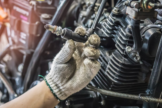 hand of Mechanic Check and a spark plugs . (maintenance) selective focus