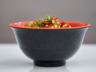 a red and green chili in a black cup