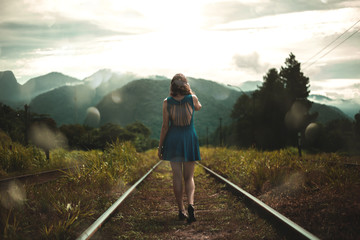 woman walking on railroad