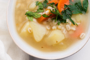 Barley soup, pearl barley in white bowl