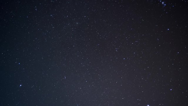 Time lapse of night sky with Orion star constellation and shooting star