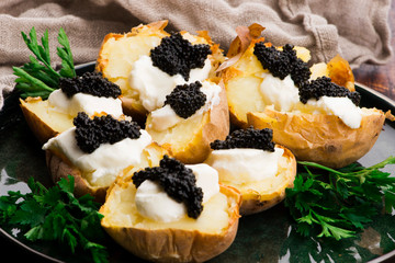 Baked potato with spiced cream cheese and caviar