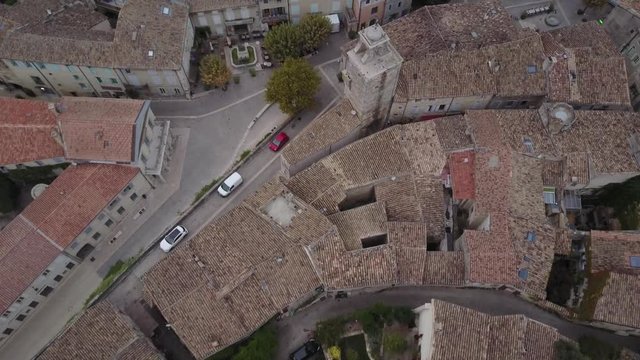 Aerial twist down grignan street village in provence at sunrise from above france