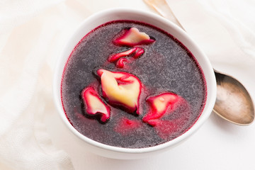 Christmas beetroot soup, borscht with small dumplings with mushroom filling