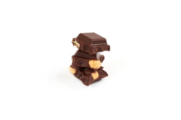 Chocolate pieces with nuts isolated on white background