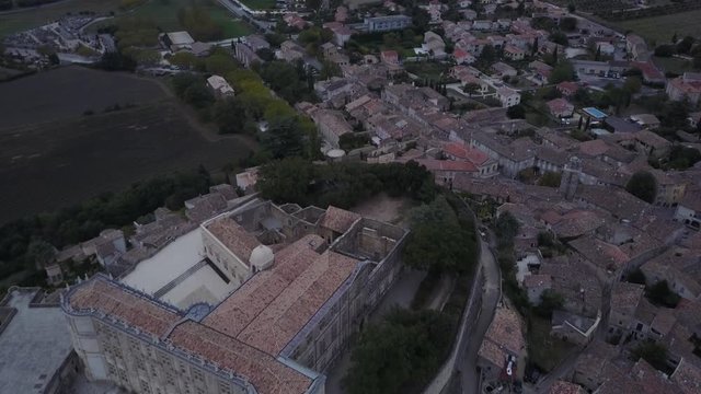 Aerial backwards Grignan village in provence at sunrise from above france