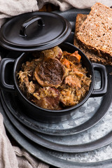 Traditional polish sauerkraut (bigos) with mushrooms and plums for christmas