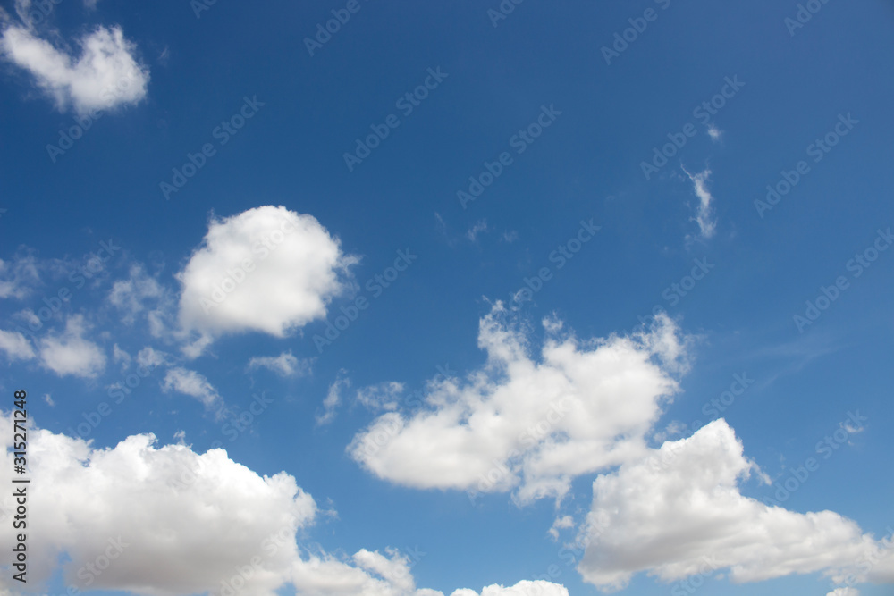 Wall mural bright blue sky with white clouds for background or wallpapers