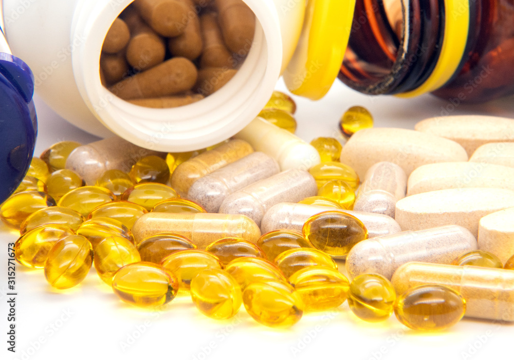 Wall mural vitamins, omega 3, cod-liver oil, dietary supplement and tablets an embankment on a light background