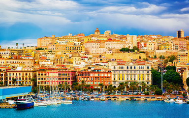 Old Sardinian Port with ships at Mediterranean Sea and city of Cagliari, South Sardinia Island in...
