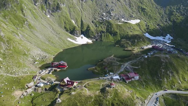 4K Balea Lake Romania Drone Orbit Shot Summer Wooden Cabin Sunset