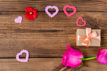 Present gift box, flower and heart for Valentine day on the wooden background