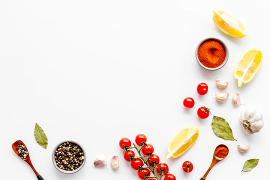 Kitchen Frame With Spices And Food - Pepper, Garlic, Cherry Tomatoes - On White Background Top-down Frame Copy Space