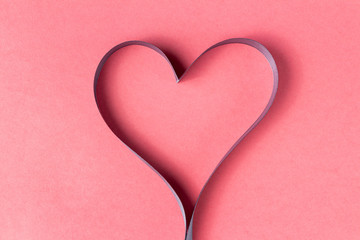 Heart shaped ribbon on a pink background. Valentine's Day Gift