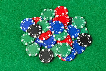 Casino chips on green table