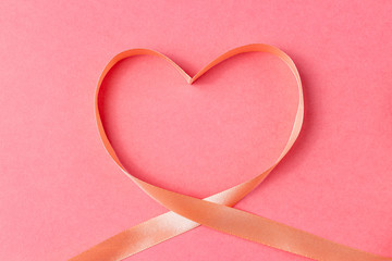 Heart shaped ribbon on a pink background. Valentine's Day Gift