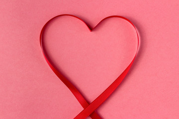 Heart shaped ribbon on a pink background. Valentine's Day Gift