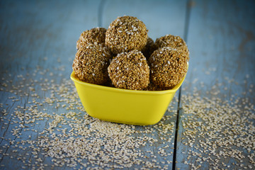 Sesame laddu in bowl on wooden background