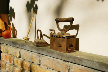 vintage iron. retro coal heated iron on a stone shelf