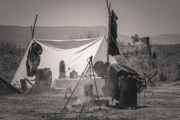Cowboys set fires to boil water in rural areas with mountains.