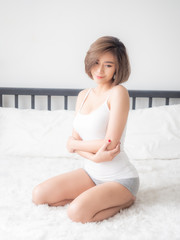 Sexy asian woman lying on the bed in the bedroom