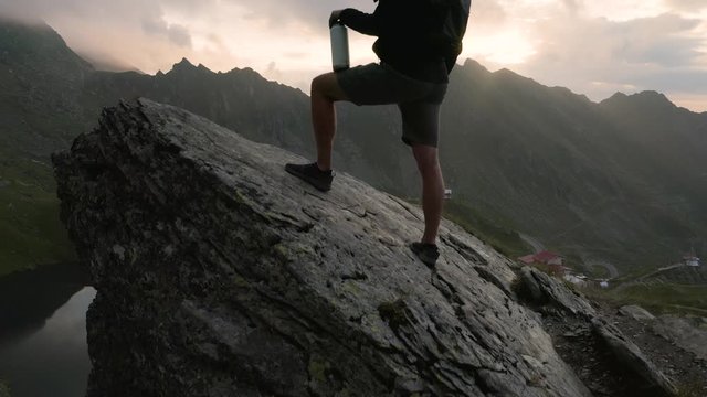 4K Man Looks at Transfagarasan Highway Glacier Lake Romania Sunrise