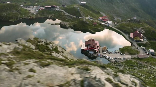 4K Balea Lake Transfagarasan Mountain Sunset Reflection Aerial View Low Flying