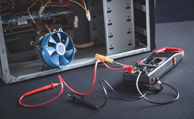 Computer with a multimeter. Checking. Repair