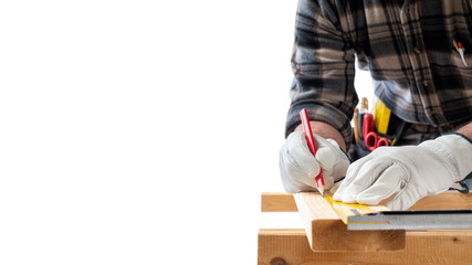Close-up. Carpenter with his hands protected by gloves, with pencil and carpenter's square draw the...