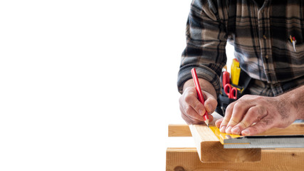 Close-up. Carpenter with pencil and carpenter's square draw the cutting line on a wooden board. Construction industry. White background.