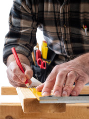 Close-up. Carpenter with pencil and carpenter's square draw the cutting line on a wooden board. Construction industry. White background.