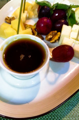 cheese plate with honey, fruit and nuts