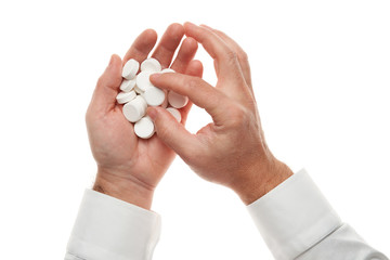 Man hand with handful of big white pills isolated on white background. White shirt, business style. Medicament and food supplement for health care. Pharmaceutical industry. Pharmacy.