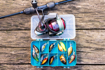 fishing rod and reel with fishing line on a wooden background