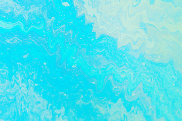 Fototapeta na wymiar Blue, green, yellow color oil patterns on the surface of the water