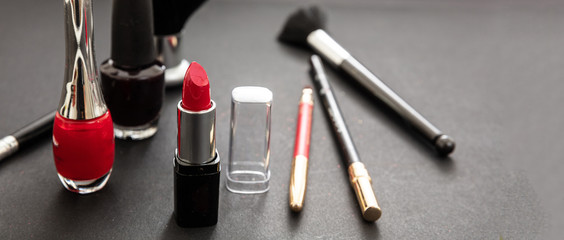 Make-up cosmetics accessories against black background
