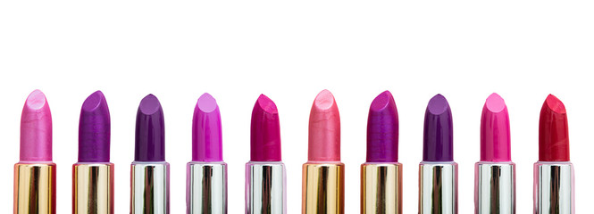 Lipsticks various colors against white background, closeup view