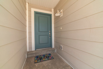 Recessed covered front door with Hello welcome mat