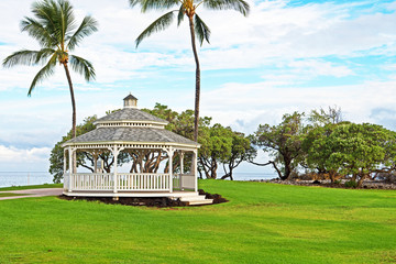 A gazebo sits under palm trees on the edge of the Pacific Ocean on the island of Hawaii (Big...
