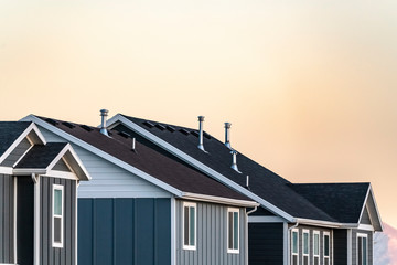 Roofs of modern urban houses at sunset