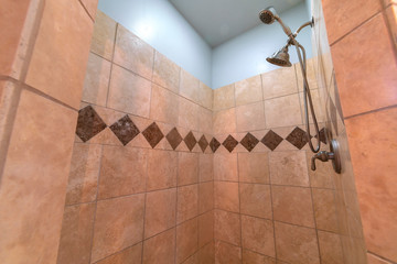 Tiled shower with decorative diamond pattern bright interior