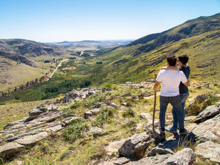 Young homosexual couple looking at the view in Cerro Bahía Blanca